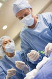 Surgeons Preparing Equipment For Surgery