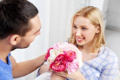 Happy couple with flowers at home royalty free stock image Happy couple with flowers at home royalty free stock image