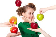 Surprised Girl Choose Among Proposed Apples Stock Photography
