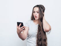 Surprised girl with long hair looks at the calculator