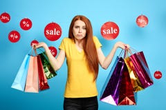 Surprised woman holding a lot of packets and looking at the camera stock photos Surprised woman holding a lot of packets and looking at the camera stock photos