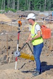 The surveyor performs topographic survey of the area for the cadastre stock photo The surveyor performs topographic survey of the area for the cadastre stock photo