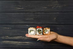 Sushi on the hand of a girl Stock Image Sushi on the hand of a girl Stock Image