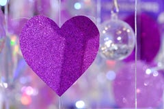 Purple heart paper mobile hanging from a string with bokeh lights stock images Purple heart paper mobile hanging from a string with bokeh lights stock images