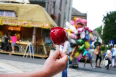 Sweet Candy Apple On County Fair Or Festival. Red Candy Apple Covered In Red Caramel, At Holiday Vacation Event Or Amusement Park Royalty Free Stock Images