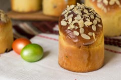 Sweet easter cake kulich topped with almond flakes with colored eggs. Selective focus royalty free stock image Sweet easter cake kulich topped with almond flakes with colored eggs. Selective focus royalty free stock image