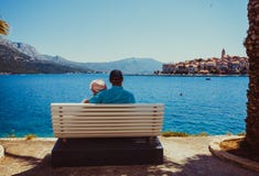 Sweet married couple sitting on a bench near the sea royalty free stock photo Sweet married couple sitting on a bench near the sea royalty free stock photo