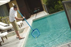 Swimming pool cleaner, professional cleaning service at work. stock photos Swimming pool cleaner, professional cleaning service at work. stock photos