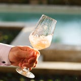 Swirling glass of rose wine at wine tasting. Concept of rose win royalty free stock images Swirling glass of rose wine at wine tasting. Concept of rose win royalty free stock images