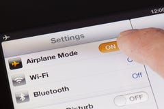 Switching to Airplane mode on an iPad royalty free stock photography Switching to Airplane mode on an iPad royalty free stock photography