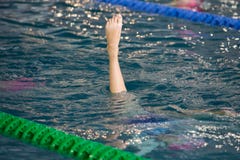Synchronized Swimmers point up out of the water in action. Synchronized swimmers legs movement. Synchronized swimming team stock images Synchronized Swimmers point up out of the water in action. Synchronized swimmers legs movement. Synchronized swimming team stock images
