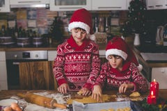 Süßes Kleinkindkind und sein älterer Bruder, Jungen, helfende Mama, die zu Hause Weihnachtsplätzchen zubereitet stockfotografie Süßes Kleinkindkind und sein älterer Bruder, Jungen, helfende Mama, die zu Hause Weihnachtsplätzchen zubereitet stockfotografie