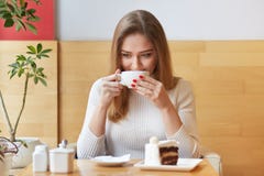 Słodka i szczera kobieta wydaje jej czas w lokalnej kawiarni, wp8lywy odpoczywa podczas lunchu, wp8lywy gorący napój w białej fil obrazy royalty free Słodka i szczera kobieta wydaje jej czas w lokalnej kawiarni, wp8lywy odpoczywa podczas lunchu, wp8lywy gorący napój w białej fil obrazy royalty free