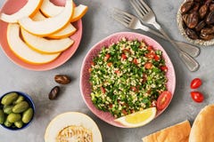 Tabbouleh Salad And Various Middle Eastern Or Arabic Food , Melon,peach,date,olives On Grey Background. Traditional Lebanese Diet Royalty Free Stock Photography Tabbouleh Salad And Various Middle Eastern Or Arabic Food , Melon,peach,date,olives On Grey Background. Traditional Lebanese Diet Royalty Free Stock Photography