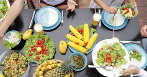 Table With Dishes Of Tropical Fruits And Salad Top Angle View People Group Eating Healthy Vegetarian Food Together stock video footage Table With Dishes Of Tropical Fruits And Salad Top Angle View People Group Eating Healthy Vegetarian Food Together stock video footage