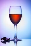 On the table is a glass of wine on a colored background royalty free stock photo On the table is a glass of wine on a colored background royalty free stock photo