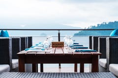 Table setting for dinner with reserved plate at tropical beach royalty free stock photography Table setting for dinner with reserved plate at tropical beach royalty free stock photography