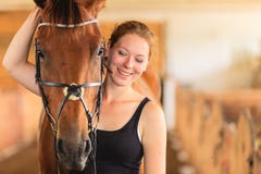 Jockey young girl petting and hugging brown horse Stock Photos Jockey young girl petting and hugging brown horse Stock Photos