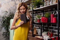 Blonde-haired girlfriend wearing bracelet taking some tea in the kitchen royalty free stock photos Blonde-haired girlfriend wearing bracelet taking some tea in the kitchen royalty free stock photos