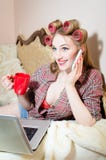 Talking on the mobile smart phone attractive happy smiling young business woman having fun in bed in pajamas Stock Image Talking on the mobile smart phone attractive happy smiling young business woman having fun in bed in pajamas Stock Image