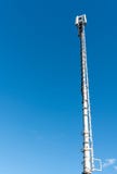 Tall antenna tower for mobile and cellular telephone service with a blue sky background stock images Tall antenna tower for mobile and cellular telephone service with a blue sky background stock images
