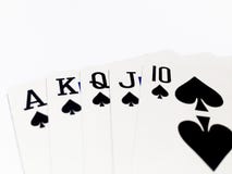Tarjeta de la escalera real en juego de póker con el fondo blanco imagen de archivo libre de regalías Tarjeta de la escalera real en juego de póker con el fondo blanco imagen de archivo libre de regalías