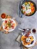 Tasty breakfast. Scrambled eggs in a pan, sandwiches with straw and cheese and Belgian waffles on a wooden white royalty free stock photos Tasty breakfast. Scrambled eggs in a pan, sandwiches with straw and cheese and Belgian waffles on a wooden white royalty free stock photos
