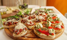 Tasty fresh sandwiches. Italian sandwiches with paprika, cheese, tomatoes and pesto sauce on a wooden plate. royalty free stock photos Tasty fresh sandwiches. Italian sandwiches with paprika, cheese, tomatoes and pesto sauce on a wooden plate. royalty free stock photos