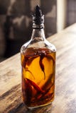Pepper Oil on a table desk, ligth behind it royalty free stock photo Pepper Oil on a table desk, ligth behind it royalty free stock photo