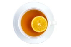 Taza de té con el limón en una opinión superior del platillo aislado en el CCB blanco imagen de archivo Taza de té con el limón en una opinión superior del platillo aislado en el CCB blanco imagen de archivo