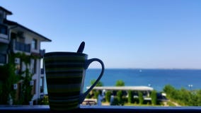 Tazza di caffè accanto al mare fotografie stock libere da diritti Tazza di caffè accanto al mare fotografie stock libere da diritti