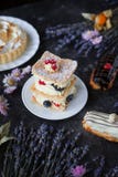 Tea And Sweets On A Dark Background, Mille-feuille, Eclairs, Tart, Decorative With Flowers, Selective Focus, Closeup Stock Image Tea And Sweets On A Dark Background, Mille-feuille, Eclairs, Tart, Decorative With Flowers, Selective Focus, Closeup Stock Image