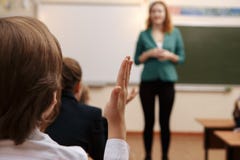 Teacher asking her students a question at the elementary school stock photos Teacher asking her students a question at the elementary school stock photos