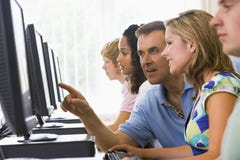 Teacher assisting college student in computer lab