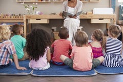 Teacher At Montessori School Reading To Children At Story Time Royalty Free Stock Photos Teacher At Montessori School Reading To Children At Story Time Royalty Free Stock Photos
