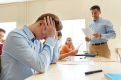 Teacher giving test results to group of students royalty free stock photo Teacher giving test results to group of students royalty free stock photo