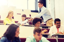 Teacher giving test to students on lecture royalty free stock photography Teacher giving test to students on lecture royalty free stock photography