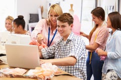 Teacher Helping College Students Studying Fashion And Design royalty free stock photo Teacher Helping College Students Studying Fashion And Design royalty free stock photo