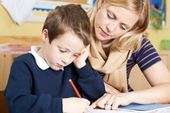 Teacher With Male Elementary School Pupil With Problem Royalty Free Stock Photos Teacher With Male Elementary School Pupil With Problem Royalty Free Stock Photos