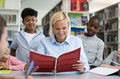 Teacher reading a book to children Stock Photo Teacher reading a book to children Stock Photo