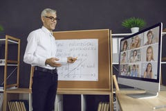 Teacher standing in front of a board and giving an online lesson to a group of students