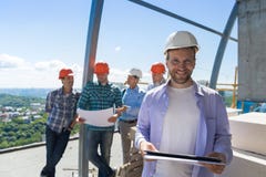 Team Of Builders On Site, Contractor Hold Plan Happy Smiling Over Apprentices Group Discussing Blueprint royalty free stock image Team Of Builders On Site, Contractor Hold Plan Happy Smiling Over Apprentices Group Discussing Blueprint royalty free stock image