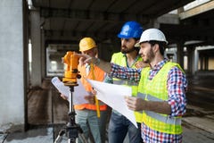 Team of business people in group, architect and engeneer on building site check documents stock photo Team of business people in group, architect and engeneer on building site check documents stock photo