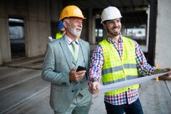 Team of business people in group, architect and engeneer on building site check documents stock image Team of business people in group, architect and engeneer on building site check documents stock image