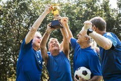 Team of mature football players winning the cup royalty free stock photos Team of mature football players winning the cup royalty free stock photos