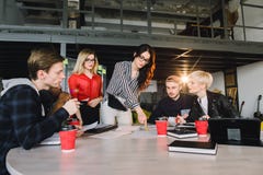 Team of young business professionals using technology in an informal meeting engaged on architect design. International royalty free stock image Team of young business professionals using technology in an informal meeting engaged on architect design. International royalty free stock image