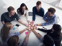 Teamwork and brainstorming concept with businessmen that share an idea with a lamp. Concept of startup stock image Teamwork and brainstorming concept with businessmen that share an idea with a lamp. Concept of startup stock image