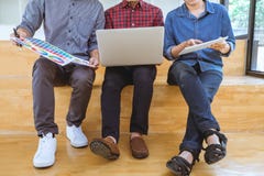 Teamwork of creative designers working on new project and choose stock photos Teamwork of creative designers working on new project and choose stock photos