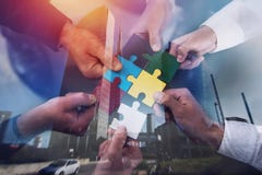 Teamwork of partners. Concept of integration and startup with puzzle pieces. double exposure Stock Image Teamwork of partners. Concept of integration and startup with puzzle pieces. double exposure Stock Image