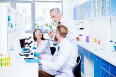 Teamwork and teambuilding concept. A group of three scientists i royalty free stock photos Teamwork and teambuilding concept. A group of three scientists i royalty free stock photos